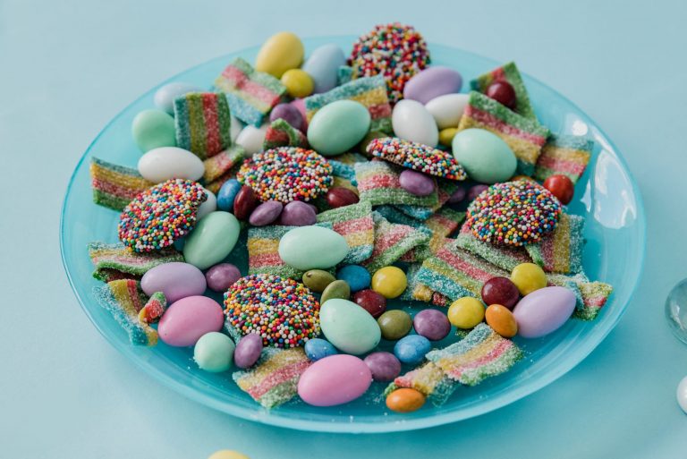 A vibrant display of assorted colorful candies on a blue plate, perfect for sweets lovers.